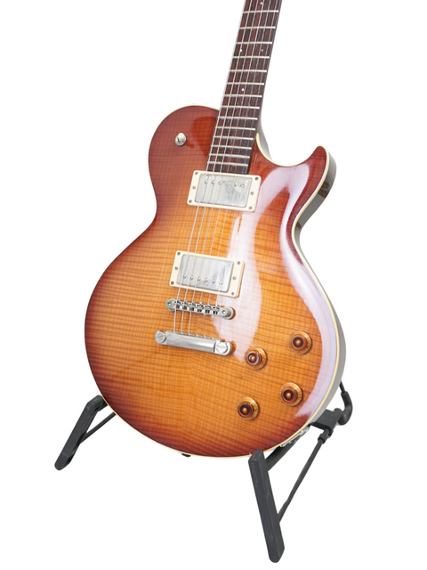 Sunburst electric guitar on a stand against a white background.