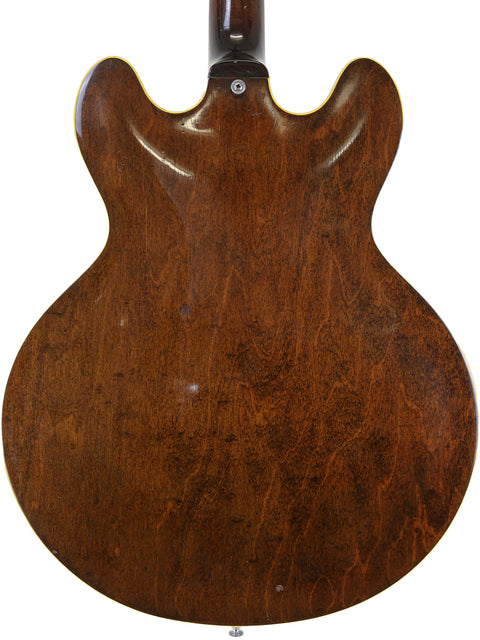 The back of a 1965 Epiphone Casino guitar showcasing its elegant brown body design.