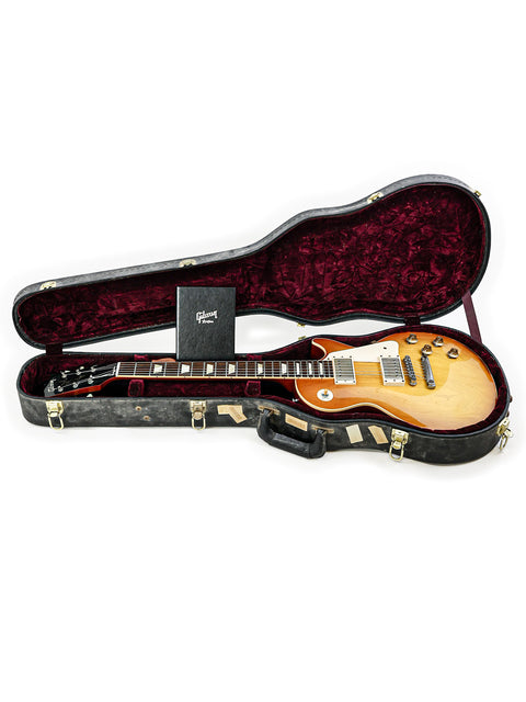 The iconic Gibson Custom Shop LPR-8 1958 Les Paul Reissue guitar is safely stored in a sleek guitar case.
