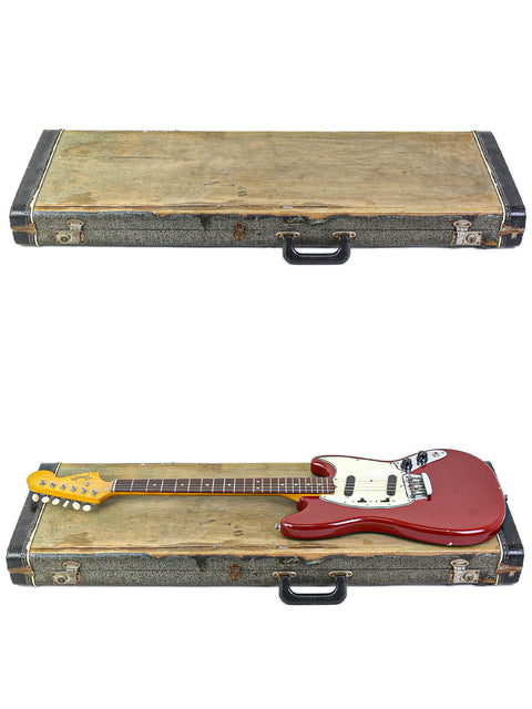 Two guitars, one a 1966 Fender Musicmaster II, securely placed in a case with an elegant wooden top.
