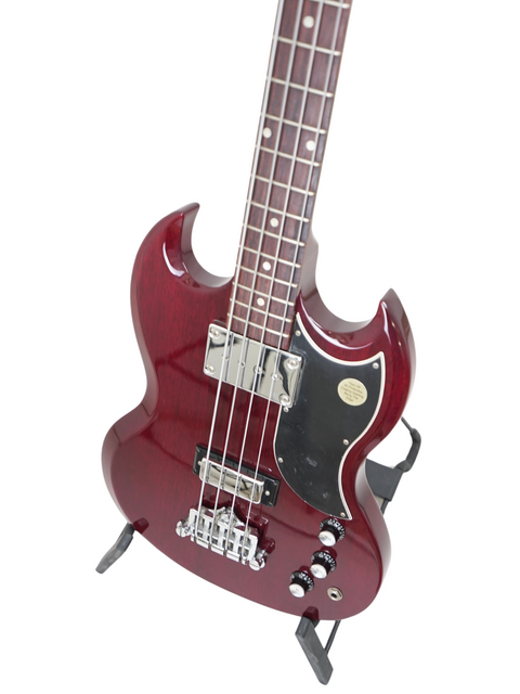 Vibrant red electric bass guitar, Gibson SG Standard Reissue 2005, elegantly positioned on a stand, ready for your next gig.