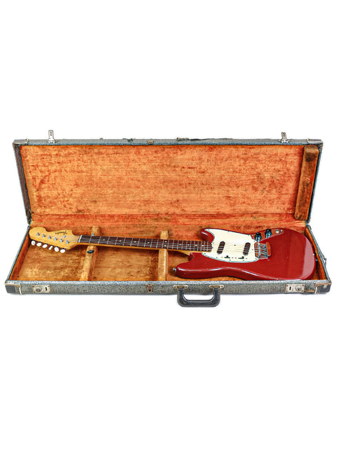 Vintage red Fender Musicmaster II guitar from 1966, resting in a case against a simple white background.