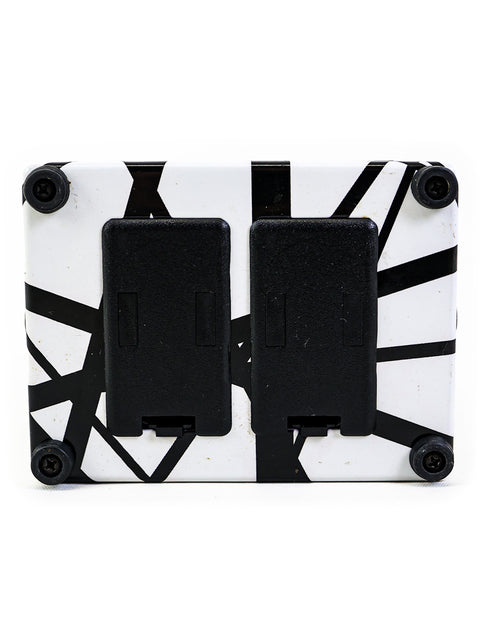 Wall-mounted MXR EVH117 Flanger Pedal featuring a sleek black and white design and two covers.