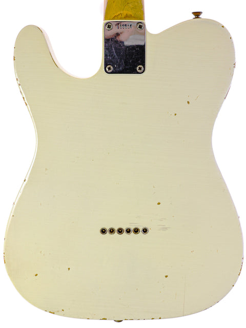 White 1963 Fender Telecaster guitar with a yellow headstock, highlighting its vintage appeal and iconic design features.