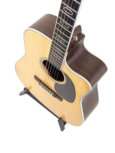 2019 Martin DC Aura GT Dreadnought guitar displayed on a stand, set against a simple white backdrop for emphasis.