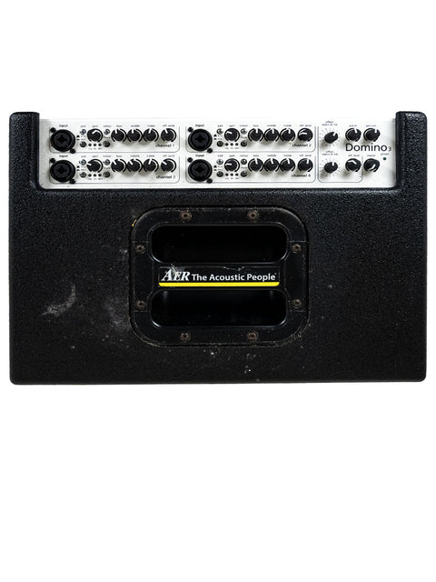 AER Domino 3 Stereo Acoustic Guitar Amplifier featuring a sleek black body with a striking yellow and black cover.
