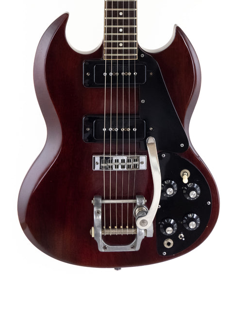A 1972 Gibson SG Pro guitar featuring a brown body and black pickguard, highlighting its vintage appeal and style.