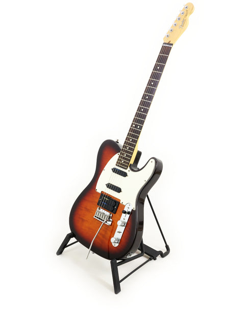 A 1992 Fender Telecaster Plus Deluxe guitar displayed on a stand, set against a bright white backdrop.