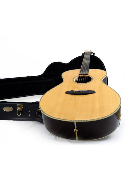A Breedlove Journey Concert Ltd Sitka/Brazilian acoustic guitar in its case, displayed against a clean white backdrop.