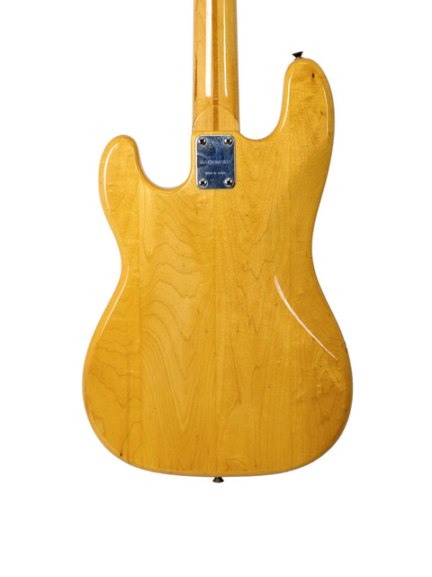 A Fender American Standard Jazz Bass featuring a maple neck and natural finish, next to a vintage Greco PB 750 from Japan.