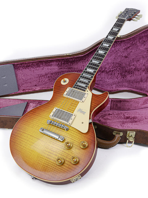 A Gibson '59 Les Paul Standard guitar from 2018, elegantly displayed in its case, highlighting the Brazilian Rosewood.
