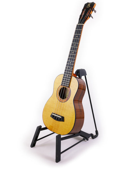 A Kanile’a Platinum Limited Edition Super Concert Ukulele from Hawaii 2017 displayed elegantly on a stand.