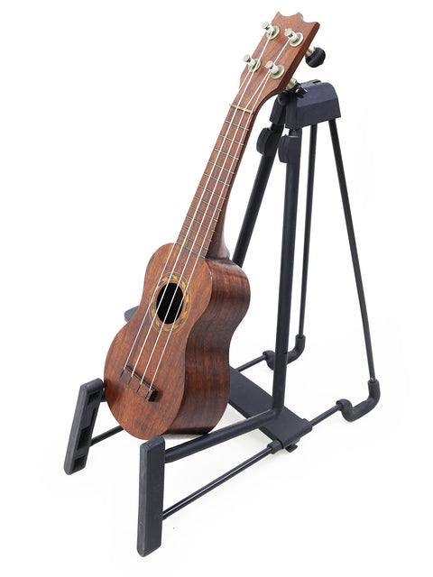A TABU Style 2 "Midget" Koa Ukulele from 1917, beautifully perched on a stand, ready to play.