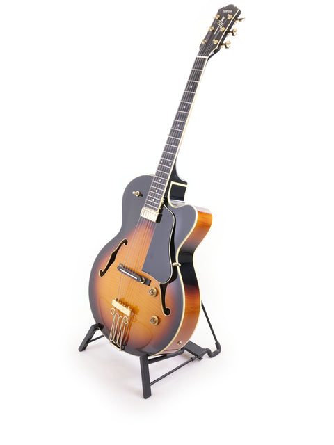 A Yamaha AEX1500 guitar from Japan, 2004, resting on a stand with a minimalist white backdrop highlighting its features.