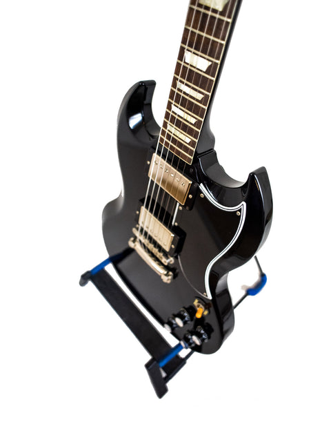 A black electric guitar displayed on a blue stand, featuring the Gibson Custom Shop Wildwood Spec 1961 SG Standard Reissue, 2015.