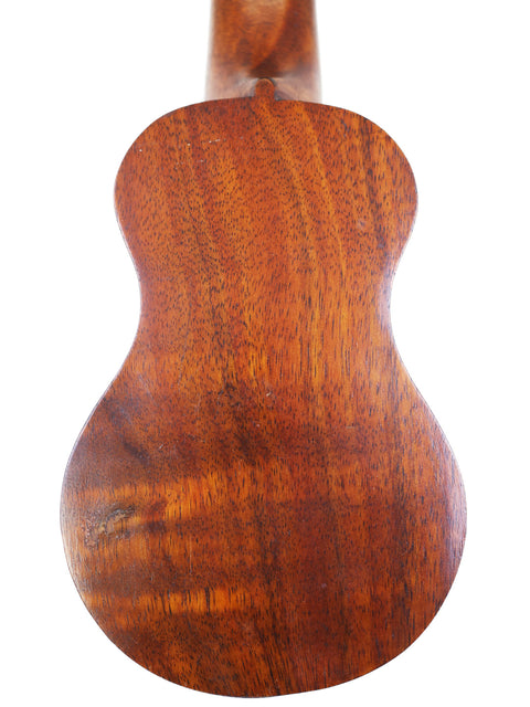 A classic Hawaiian TABU Style 2 "Midget" Koa Ukulele, showcasing its stunning wooden body and neck from 1917.