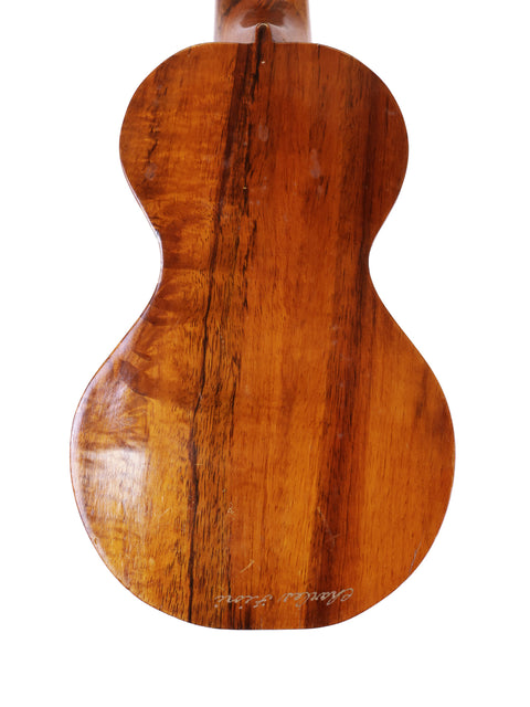 A classic Kumalae Style 2 ukulele, showcasing its wooden body and back, a piece of Hawaiian craftsmanship from 1913.