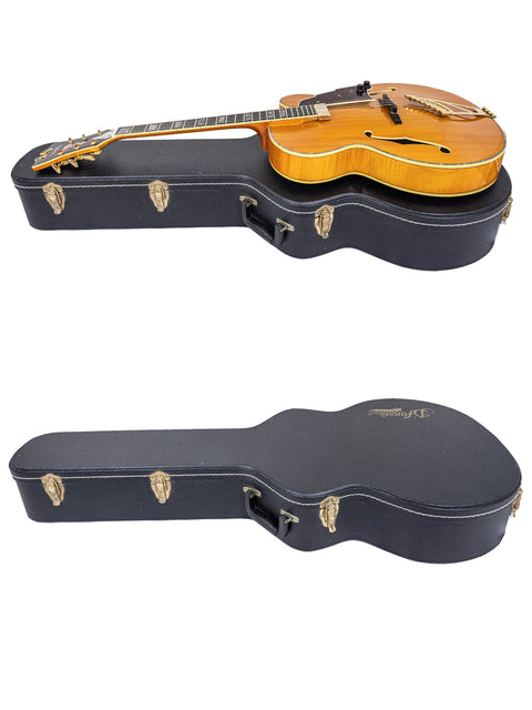 A guitar case holds two guitars, including a D’Angelico New Yorker Series Excel EXL-1DP, crafted in Korea, 2008.