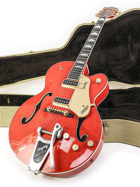 A red Gretsch G-60S electric guitar, showcasing its sleek design and vibrant color, perfect for any music enthusiast.