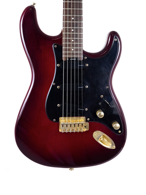 A red electric guitar featuring a black pickguard, model Levinson Blade R2 Strat Style from Japan, made in 1989.