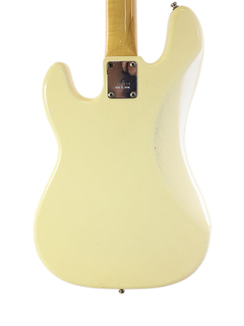 A sleek white Fender Custom Shop Stratocaster next to a vintage Ibanez Silver Series P/J Bass, crafted in Japan in 1978.