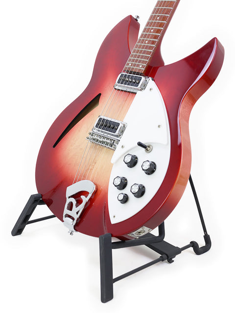 A striking red Rickenbacker 330 guitar displayed on a stand, set against a bright white background, from the USA, 2006.
