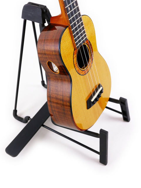 A stunning Kanile’a Platinum Limited Edition Super Concert Ukulele from Hawaii 2017 is positioned on a stand.
