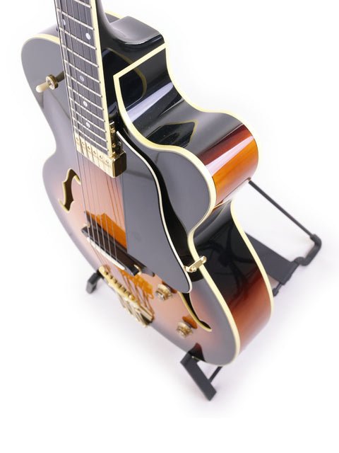 A stylish black-bodied Yamaha AEX1500 guitar resting on a stand, highlighting its craftsmanship from Japan, 2004.