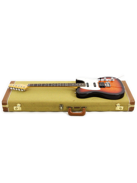 A vintage 1992 Fender Telecaster Plus Deluxe electric guitar safely stored in a case, highlighting its iconic shape.