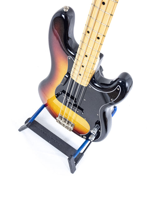 A vintage Fernandes P Bass guitar in black and orange, from Japan (1978-81), elegantly positioned on a stand.