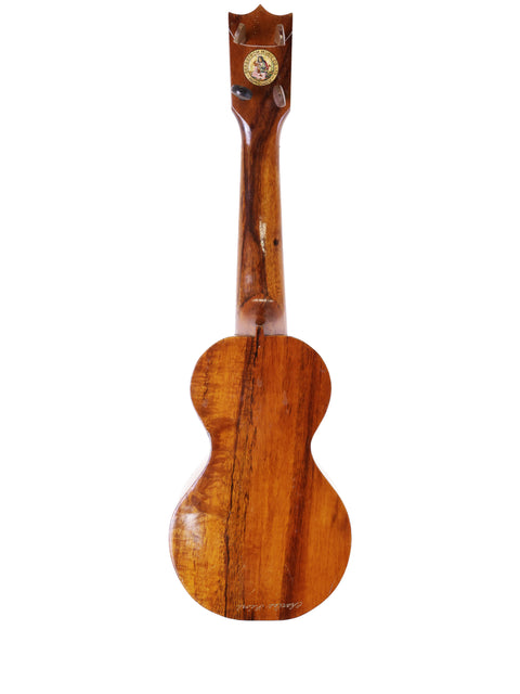 A vintage Kumalae Style 2 ukulele from Hawaii, featuring a beautifully crafted wooden body and neck, dating back to 1913.