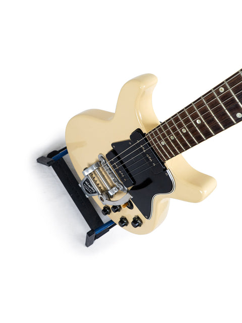 A white electric guitar with a black pick guard, representing the vintage style of a 1959 Gibson Les Paul Special Refin.