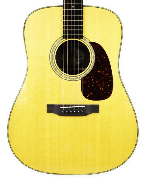 An acoustic guitar, Collings D2H from 2006, displayed against a clean white background, highlighting its elegant design.