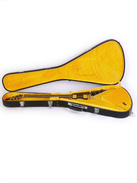 An open yellow guitar case revealing an Ibanez 2387CT Rocket Roll Sr. Flying V guitar, a classic from Japan, 1976-77.
