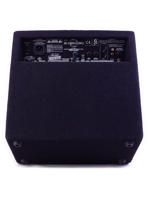 Back panel of a black guitar amplifier with various input and output ports.