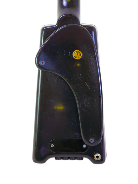 Black cell phone showcasing a vibrant yellow button, taking cues from the iconic Steinberger L2 Bass, USA, 1982.