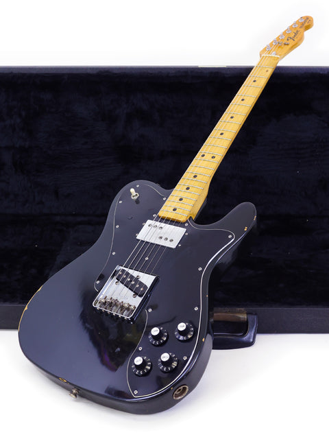 Black electric guitar, Fender Telecaster Custom from 1978, featuring a wooden body, showcasing classic craftsmanship.