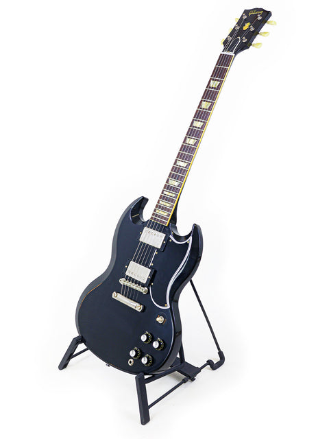 Black electric guitar on a stand, featuring the Gibson Custom Shop '64 SG Murphy Lab model from the USA, 2022.