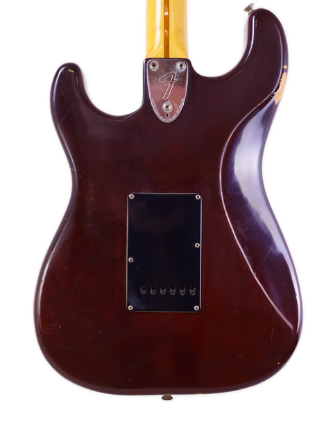 Brown-bodied 1979 Fender Stratocaster guitar with gold hardware, representing vintage American guitar design and quality.