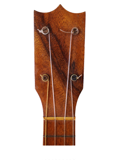 Close-up of a Kumalae Style 2 ukulele from 1913, showcasing the inscription "made in America" on its wooden surface.