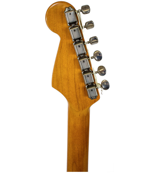 Close-up of a guitar head from a 1996 Fender American Vintage 62 Strat, highlighting its wooden body and bold Fiesta Red color.