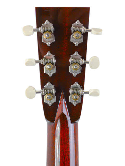 Close-up of a guitar headstock with tuning pegs against a white background.
