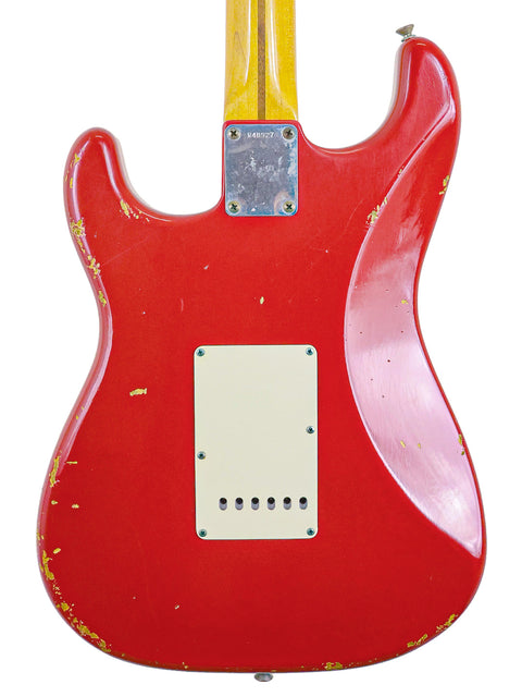 Close-up of a red Fender Custom Shop ’56 Stratocaster Relic guitar featuring a striking yellow pickguard, from 2008.