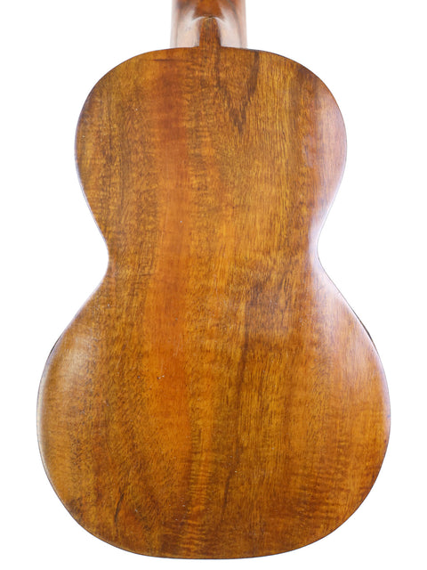 Close-up of the back of the Aloha/Akai Style 2 Concert Ukulele, emphasizing the natural wood texture and aged finish.