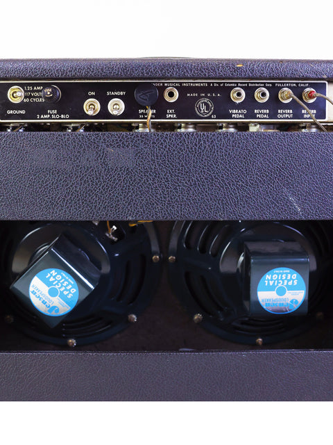 Close-up shot of a 1966 Fender Vibrolux Reverb amplifier, featuring two speakers, emphasizing its retro aesthetic.
