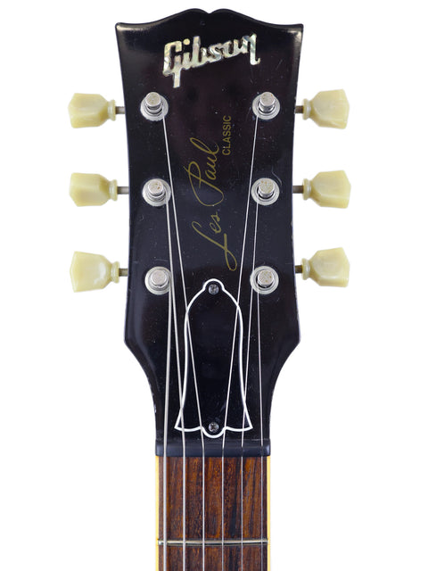 Detailed view of a Gibson guitar headstock with the "Gibson" name, showcasing a 1998 Les Paul Classic 1960 Reissue.
