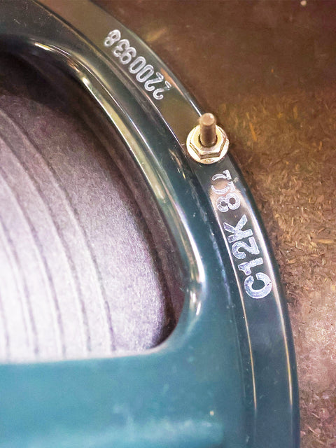 Detailed view of a green tire with a screw, reflecting a vintage aesthetic akin to the 1967 Fender Deluxe Reverb amplifier.