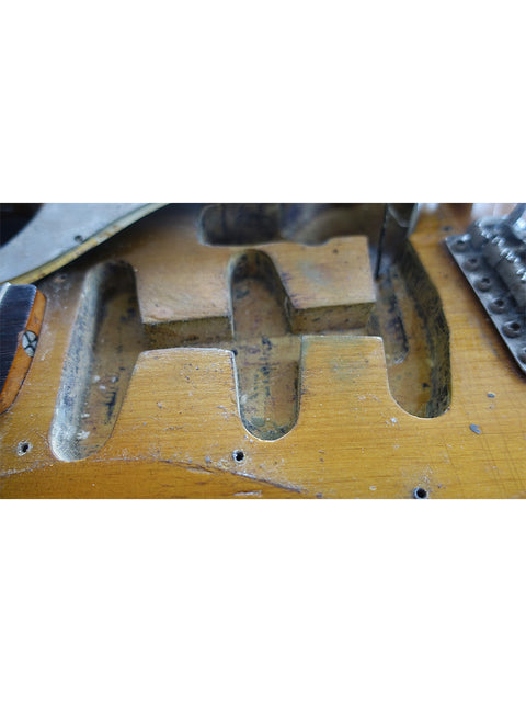 Detailed view of the inside of a 1963 USA L Series Stratocaster guitar, highlighting its vintage construction and materials.
