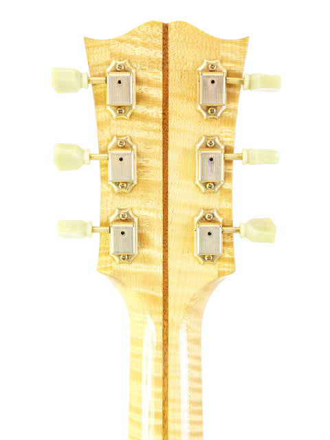Detailed view of the neck of a 2001 Gibson SJ-200 electric guitar, highlighting its smooth finish and elegant inlays.