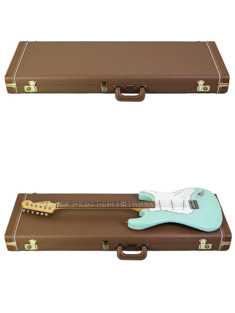 Inside a case, a green Fender Custom Shop Stratocaster is displayed on top of two guitars, emphasizing its classic style.